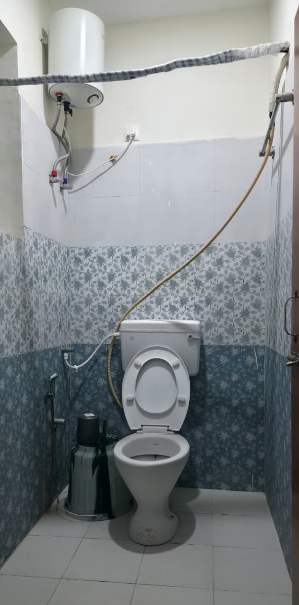 Attached bathroom with a western toilet, water heater and hand shower